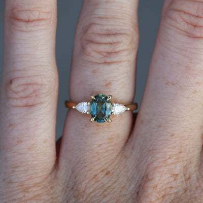 1.11ct oval cut australian sapphire trilogy engagement ring on hand