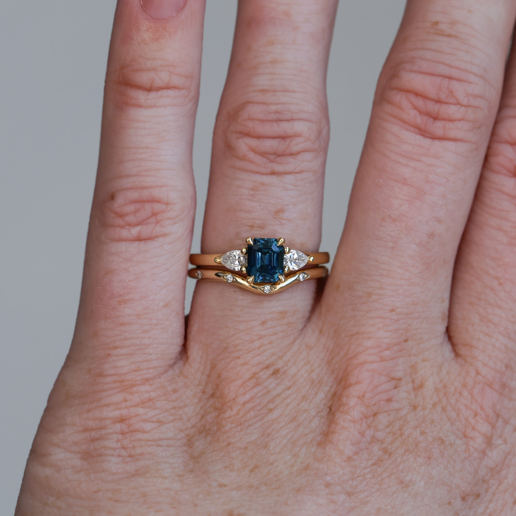 1.13ct Emerald cut madagascan sapphire trilogy engagement ring with wedding band