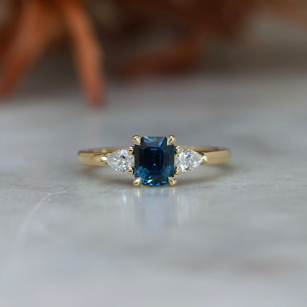 1.13ct emerald cut Madagascan sapphire trilogy engagement ring front view