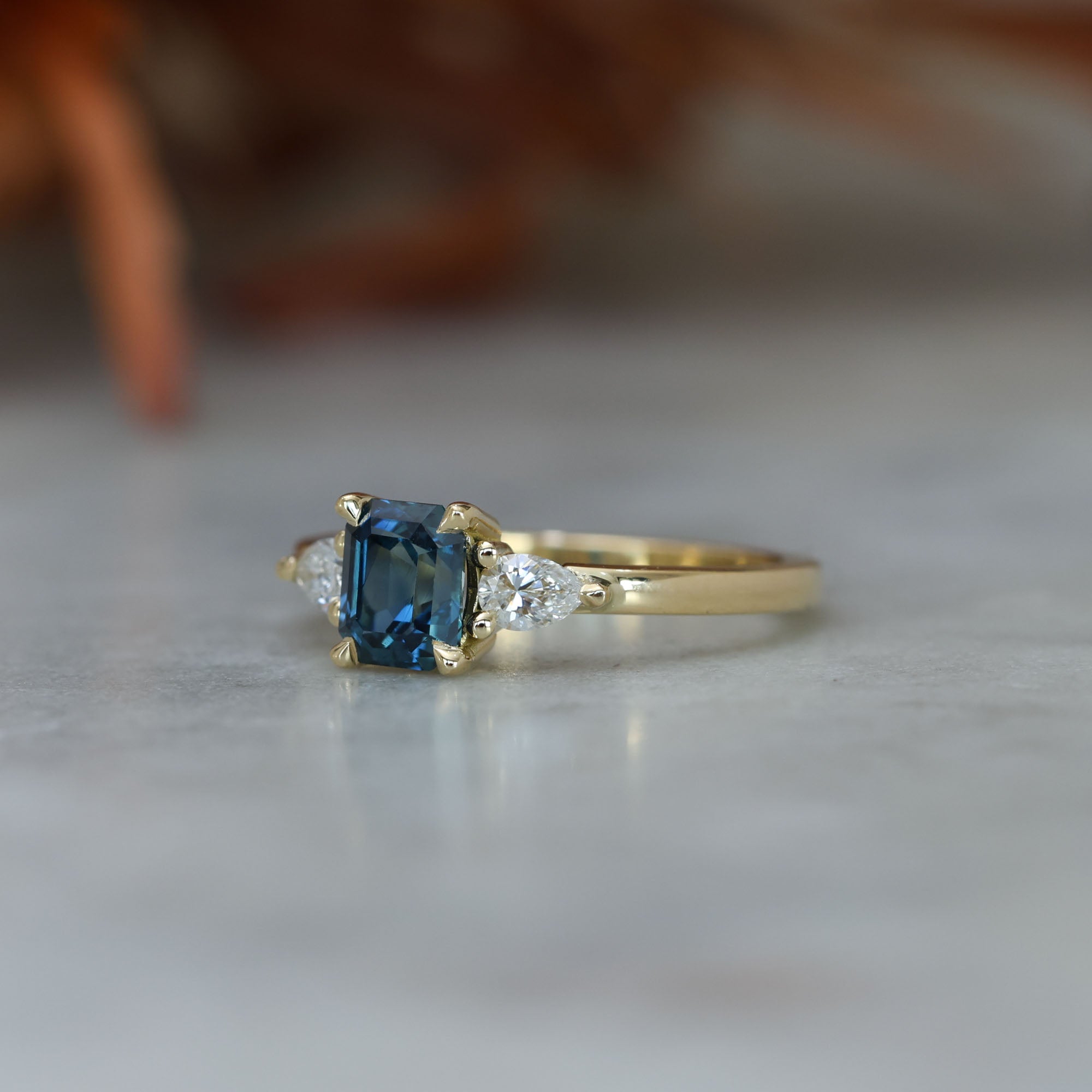 1.13ct emerald cut Madagascan sapphire trilogy engagement ring front side view