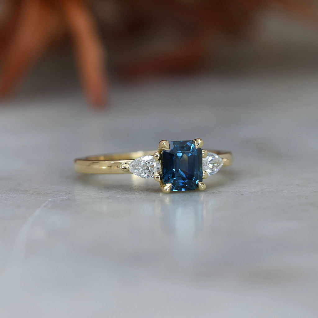 1.13ct emerald cut Madagascan sapphire trilogy engagement ring front side view