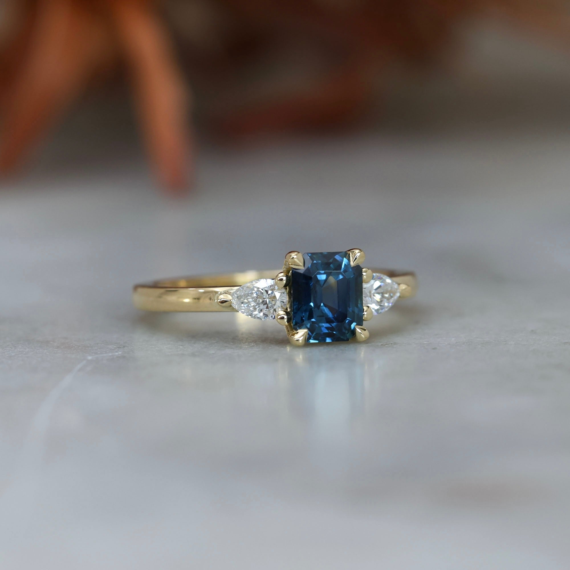 1.13ct emerald cut Madagascan sapphire trilogy engagement ring front side view