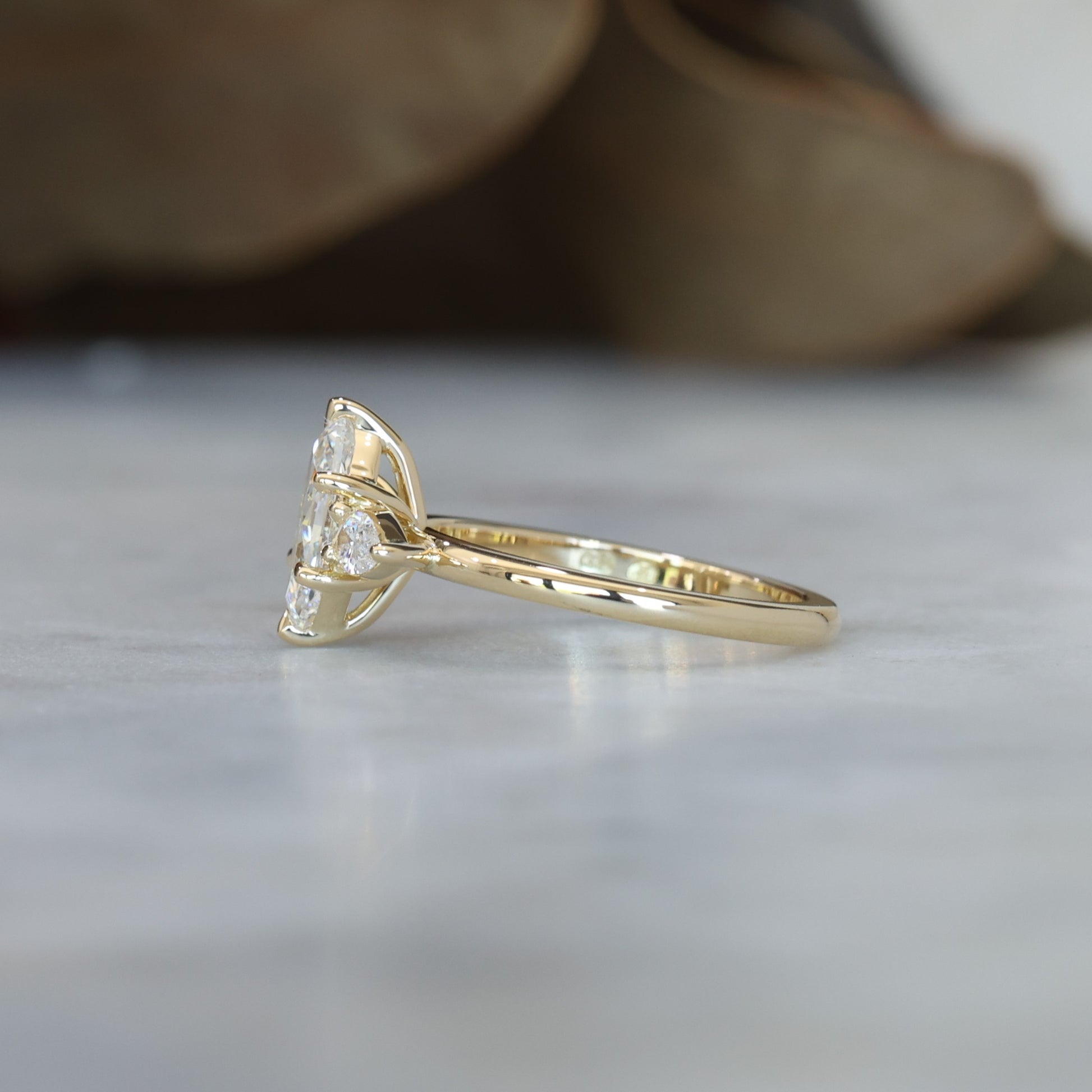 1.15ct Elongated Hexagon Diamond trilogy engagement ring side profile view