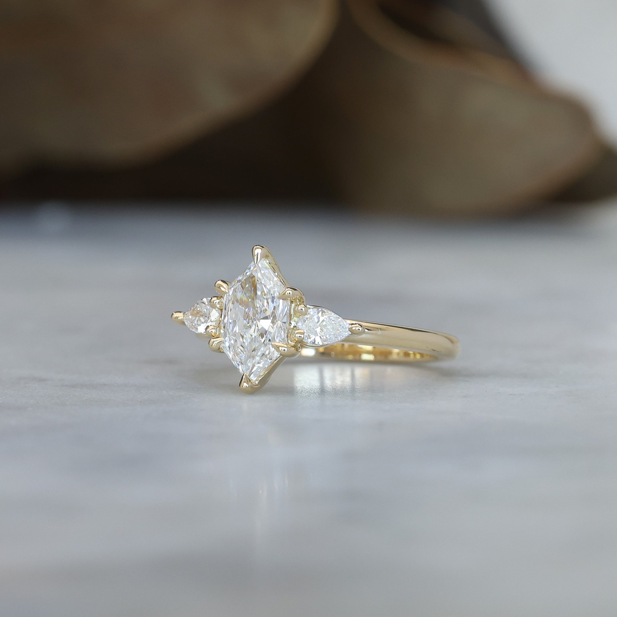 1.15ct Elongated Hexagon Diamond trilogy engagement ring side view