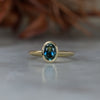 Bezel set oval cut Australian parti sapphire engagement ring in 18ct yellow gold 