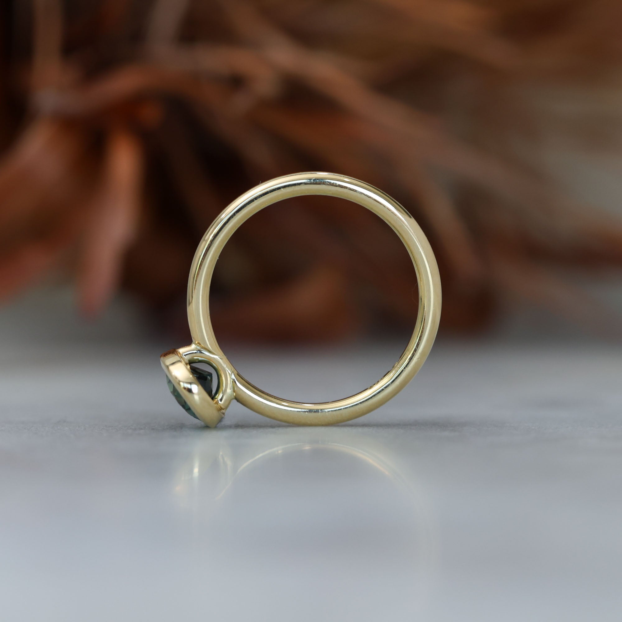 Bezel set oval cut Australian parti sapphire engagement ring side profile