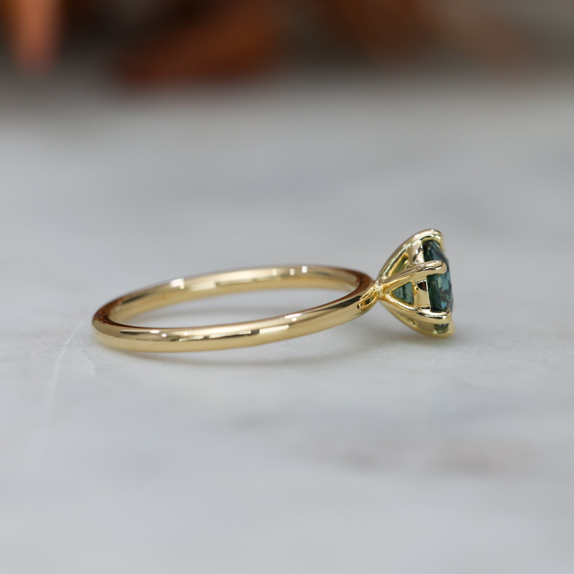 1.20ct round cut madagascan sapphire solitaire engagement ring, set in 18ct yellow gold profile view