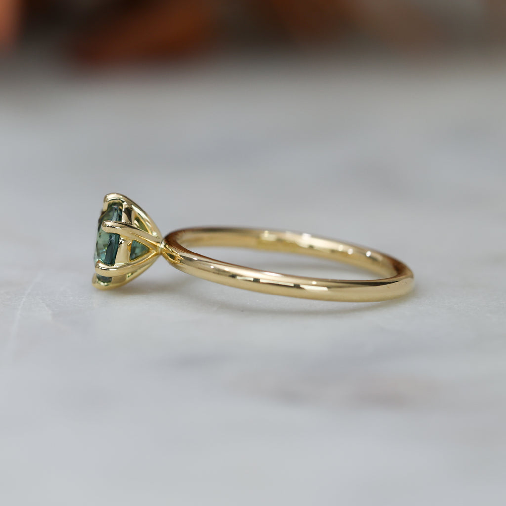 1.20ct round cut madagascan sapphire solitaire engagement ring, set in 18ct yellow gold side view