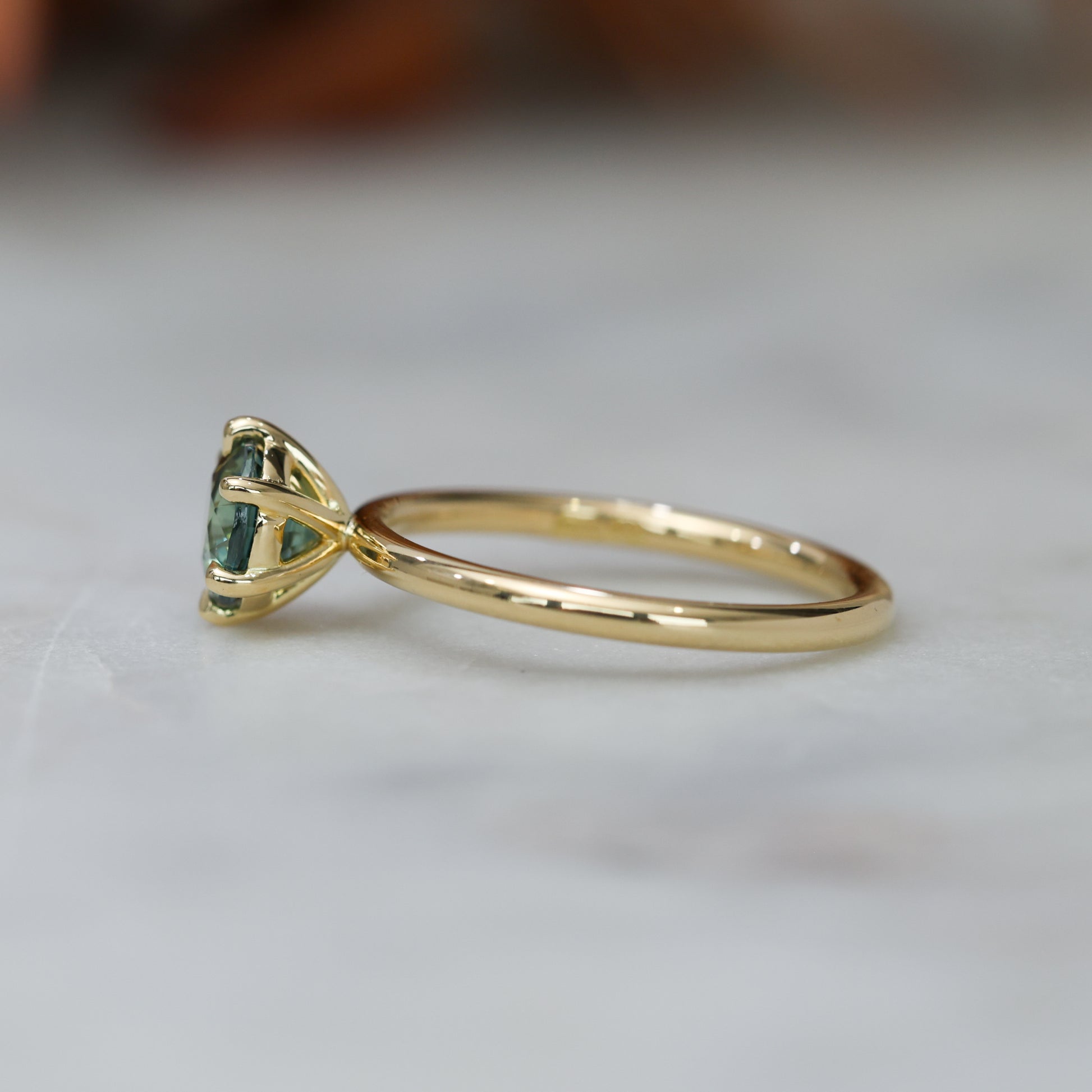 1.20ct round cut madagascan sapphire solitaire engagement ring, set in 18ct yellow gold side view