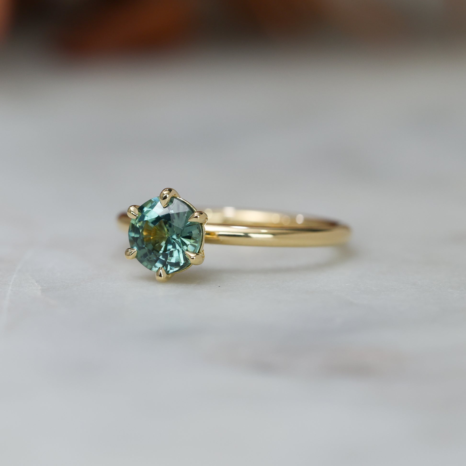 1.20ct round cut madagascan sapphire solitaire engagement ring, set in 18ct yellow gold front side view