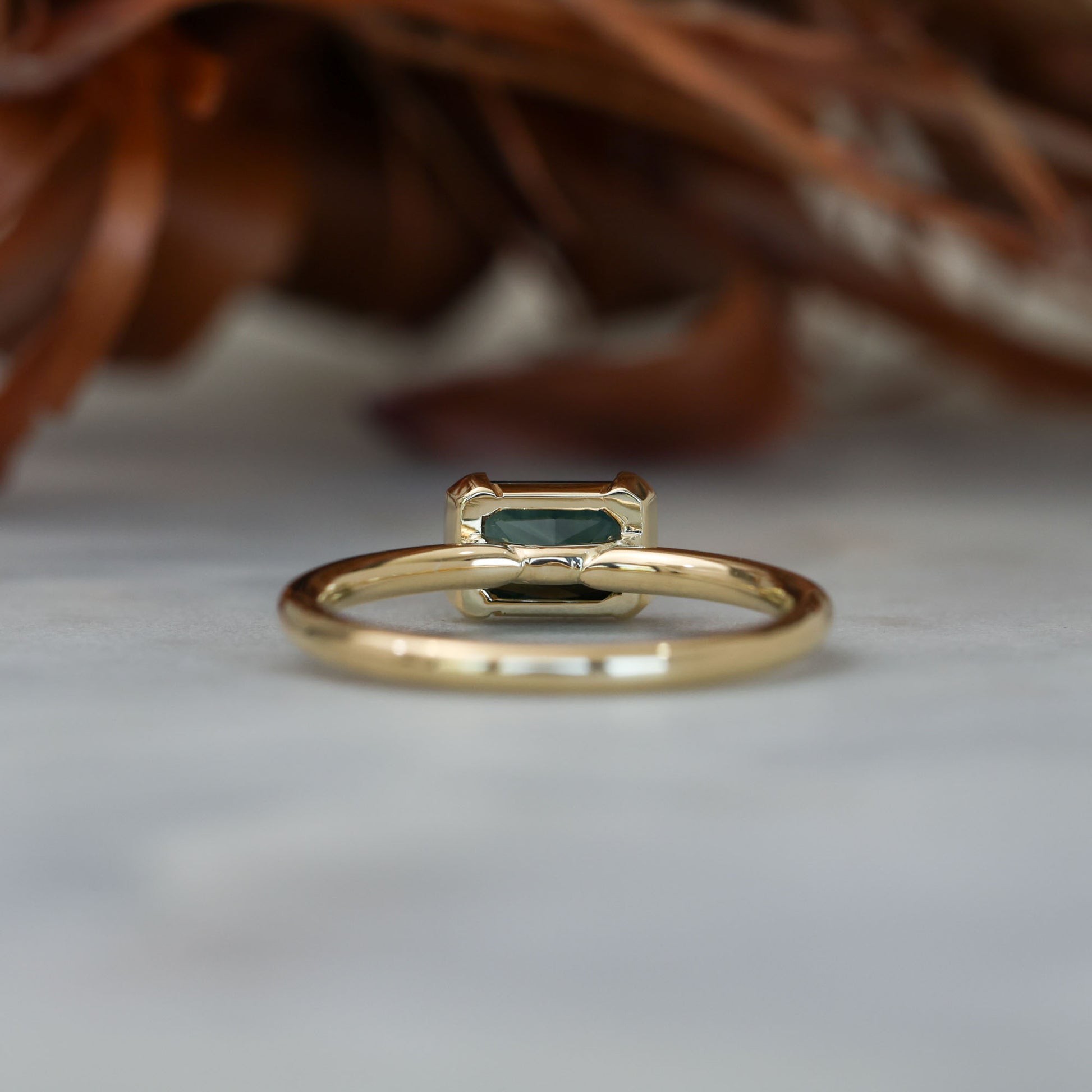 1.20ct emerald cut australian parti saphire east west semi bezel engagement ring back 