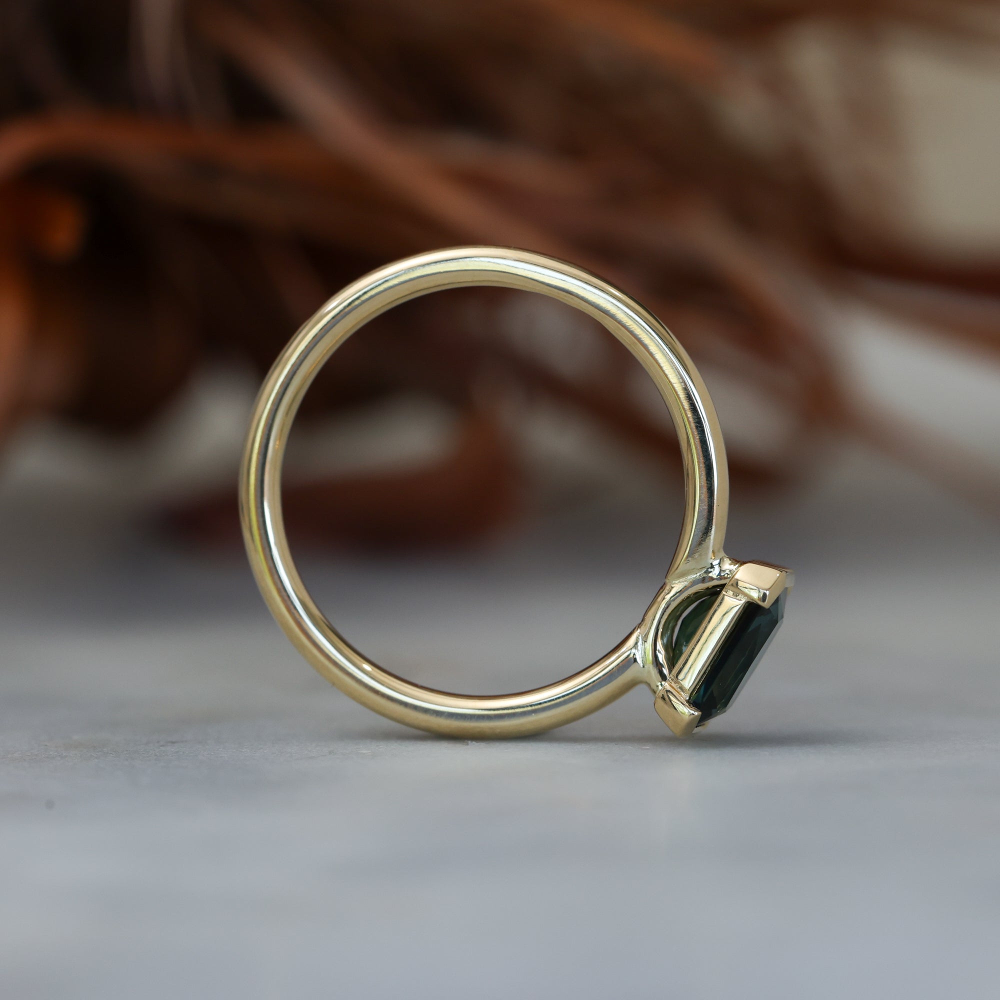 1.20ct emerald cut australian parti saphire east west semi bezel engagement ring profile