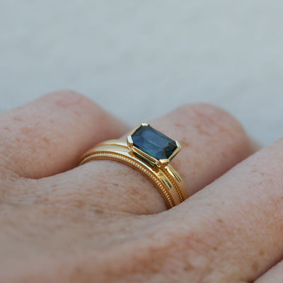 1.20ct emerald cut australian parti saphire east west semi bezel engagement ring profile with wedding band