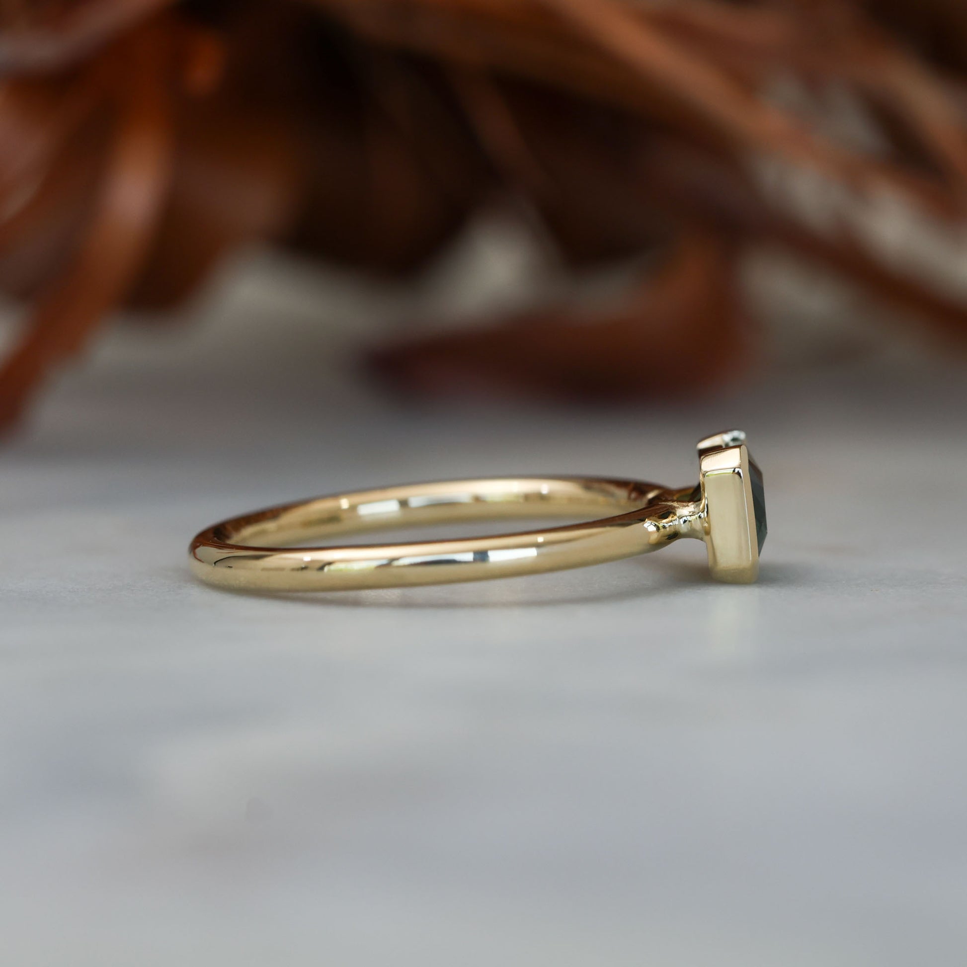 1.20ct emerald cut australian parti saphire east west semi bezel engagement ring side profile