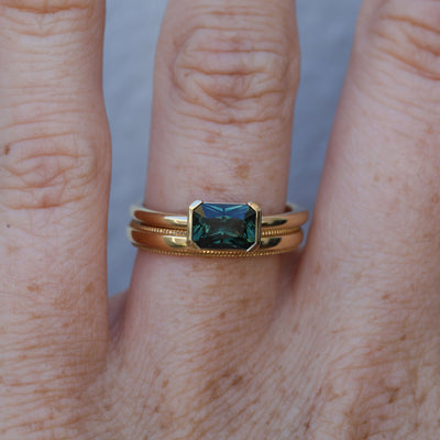 1.20ct emerald cut australian parti saphire east west semi bezel engagement ring with wedding band