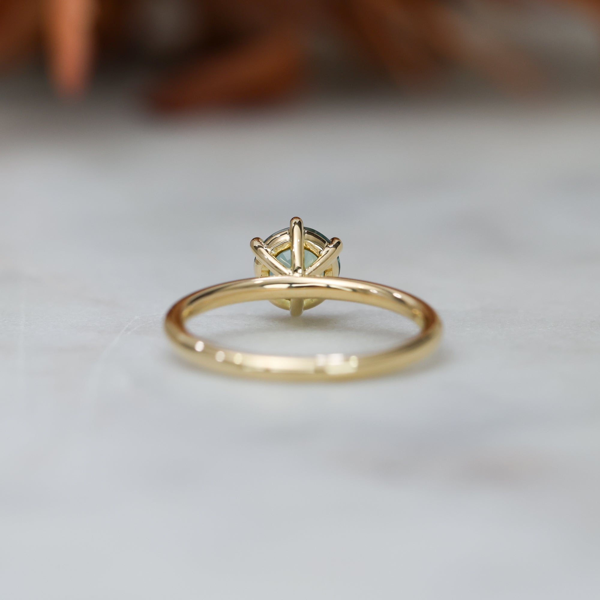 1.20ct round cut madagascan sapphire solitaire engagement ring, set in 18ct yellow gold back view