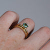 1.20ct round cut madagascan sapphire solitaire engagement ring on hand with millgrain wedding band