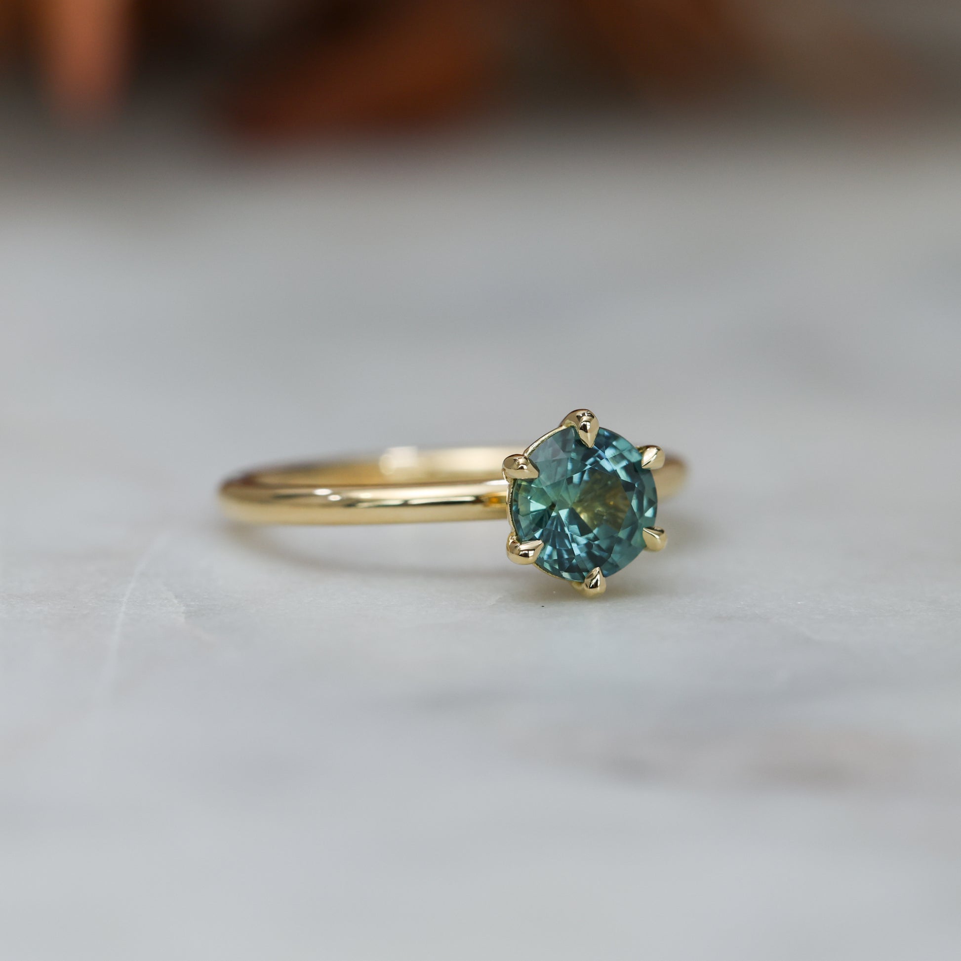 1.20ct round cut madagascan sapphire solitaire engagement ring, set in 18ct yellow gold side view