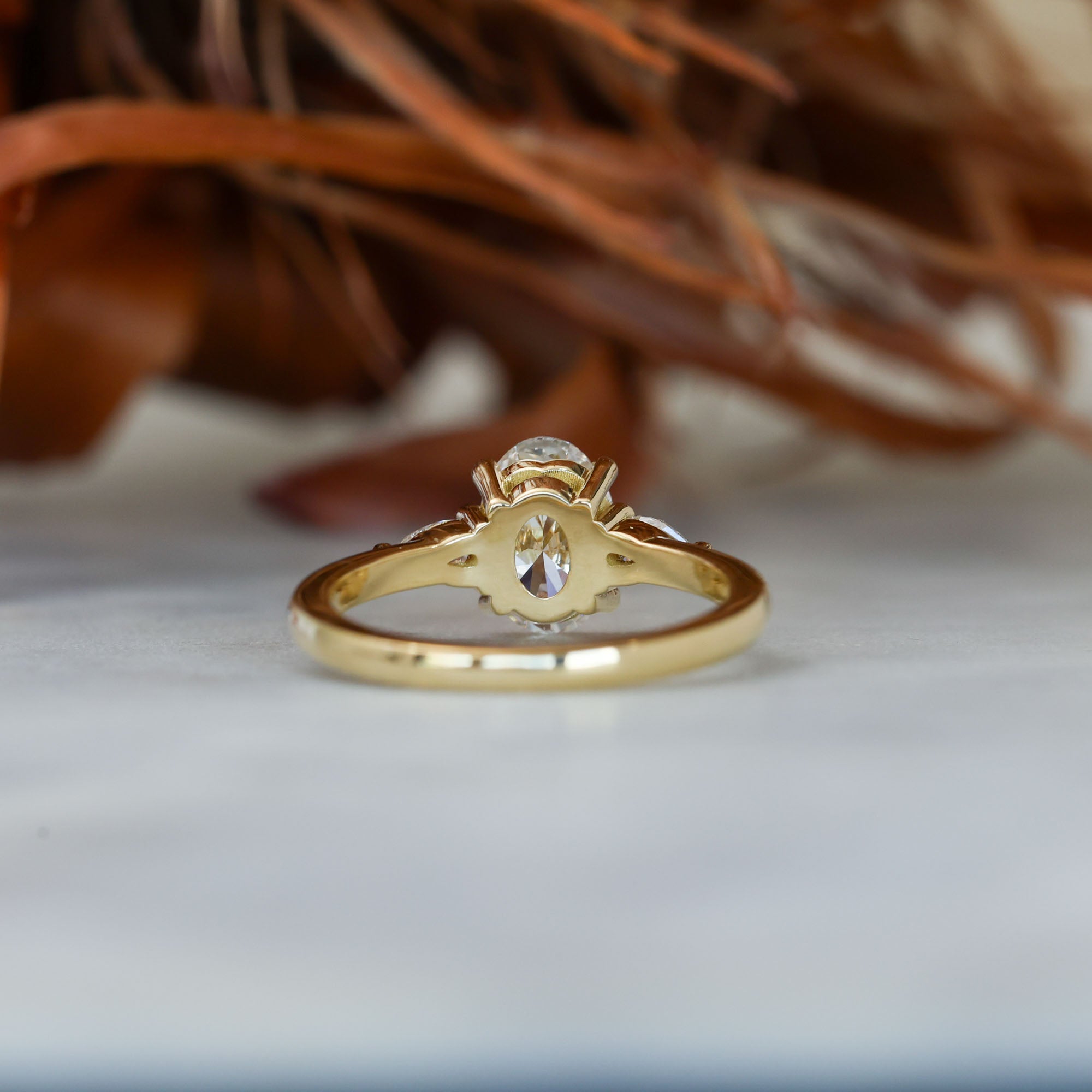 1.25ct oval cut diamond may trilogy engagement ring back