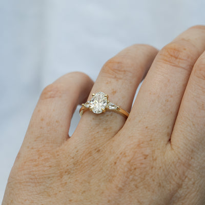 1.25ct oval cut diamond may trilogy engagement ring on hand