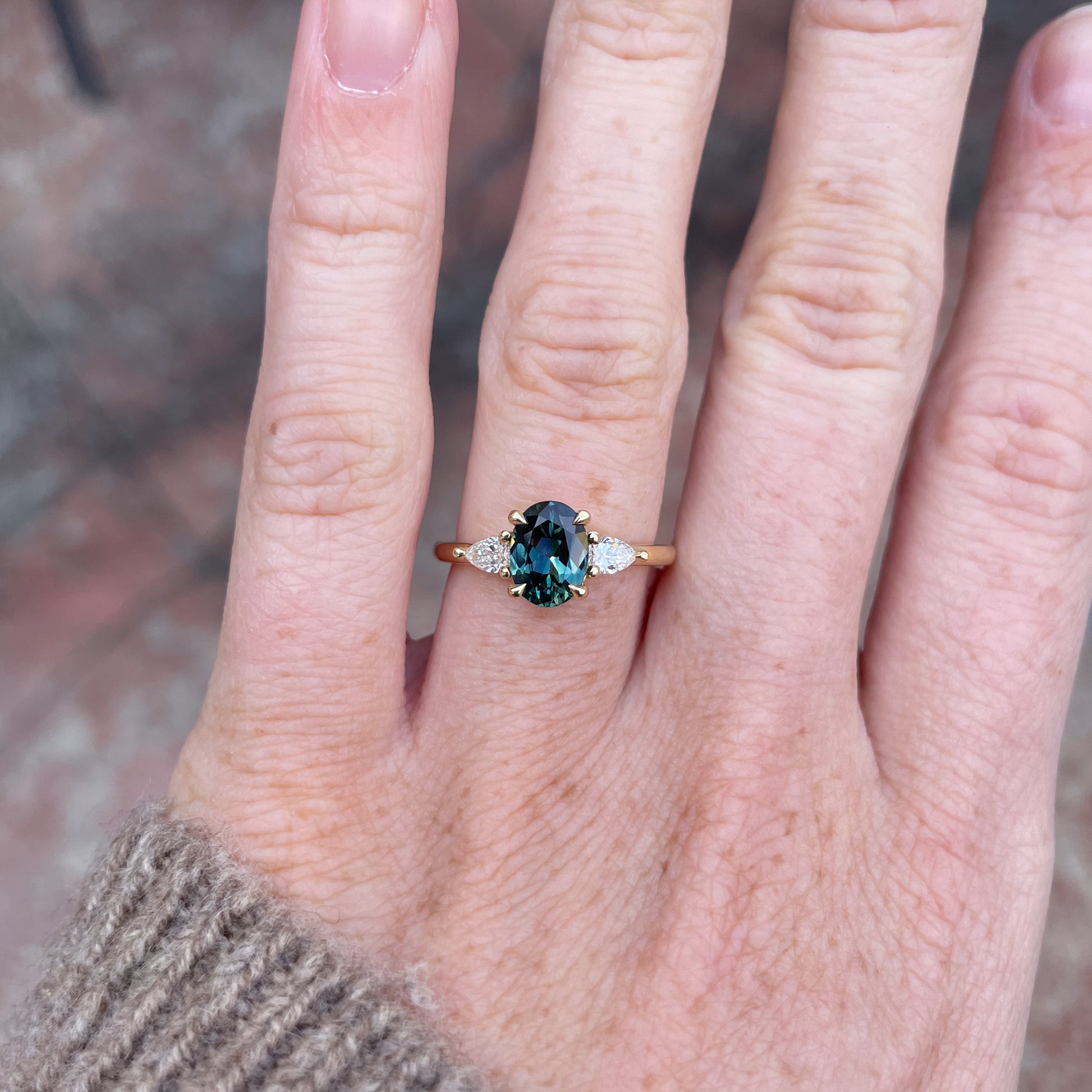 1.31ct Oval Cut australian Parti sapphire trilogy engagement ring on hand