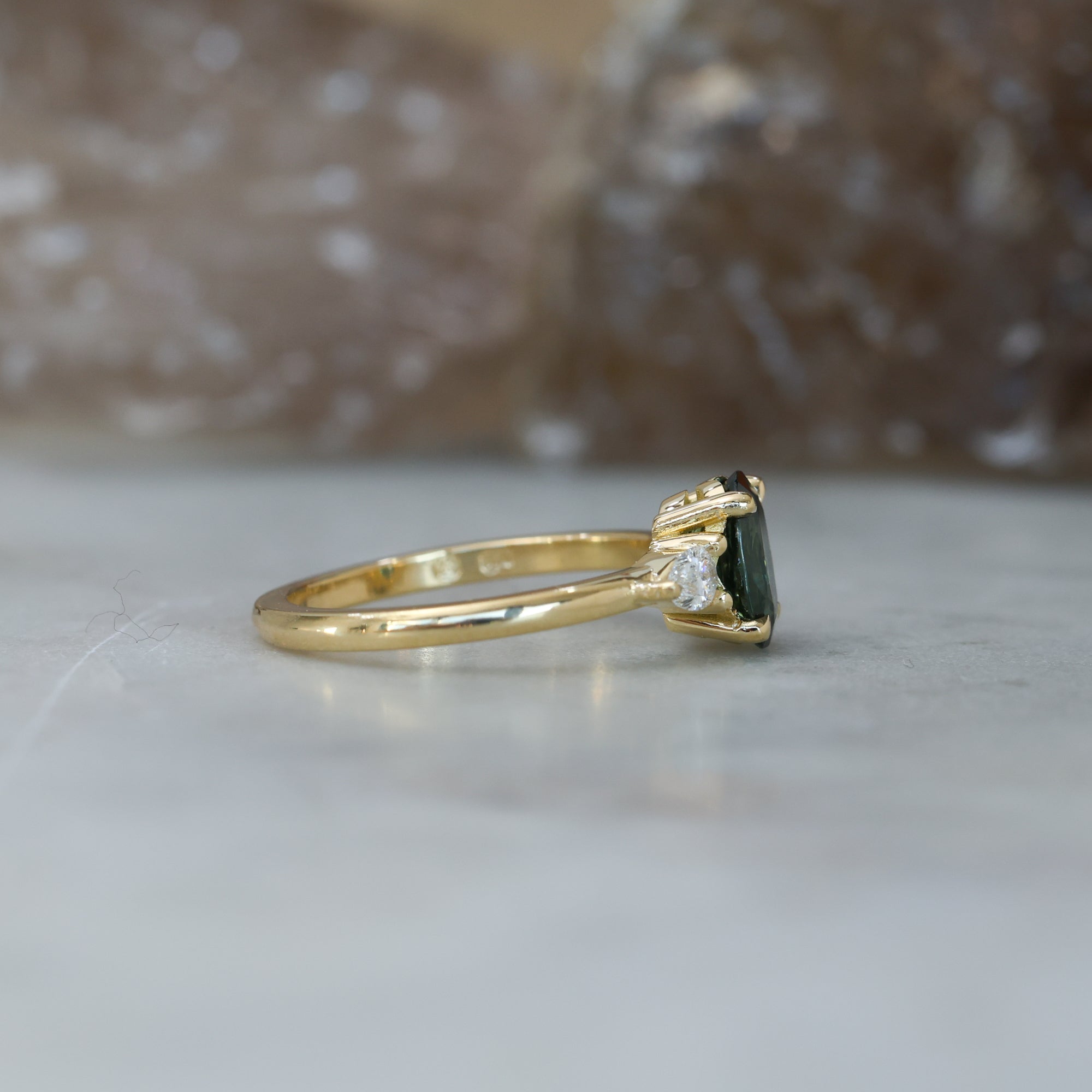 1.31ct oval cut australian Parti sapphire trilogy engagement ring side view