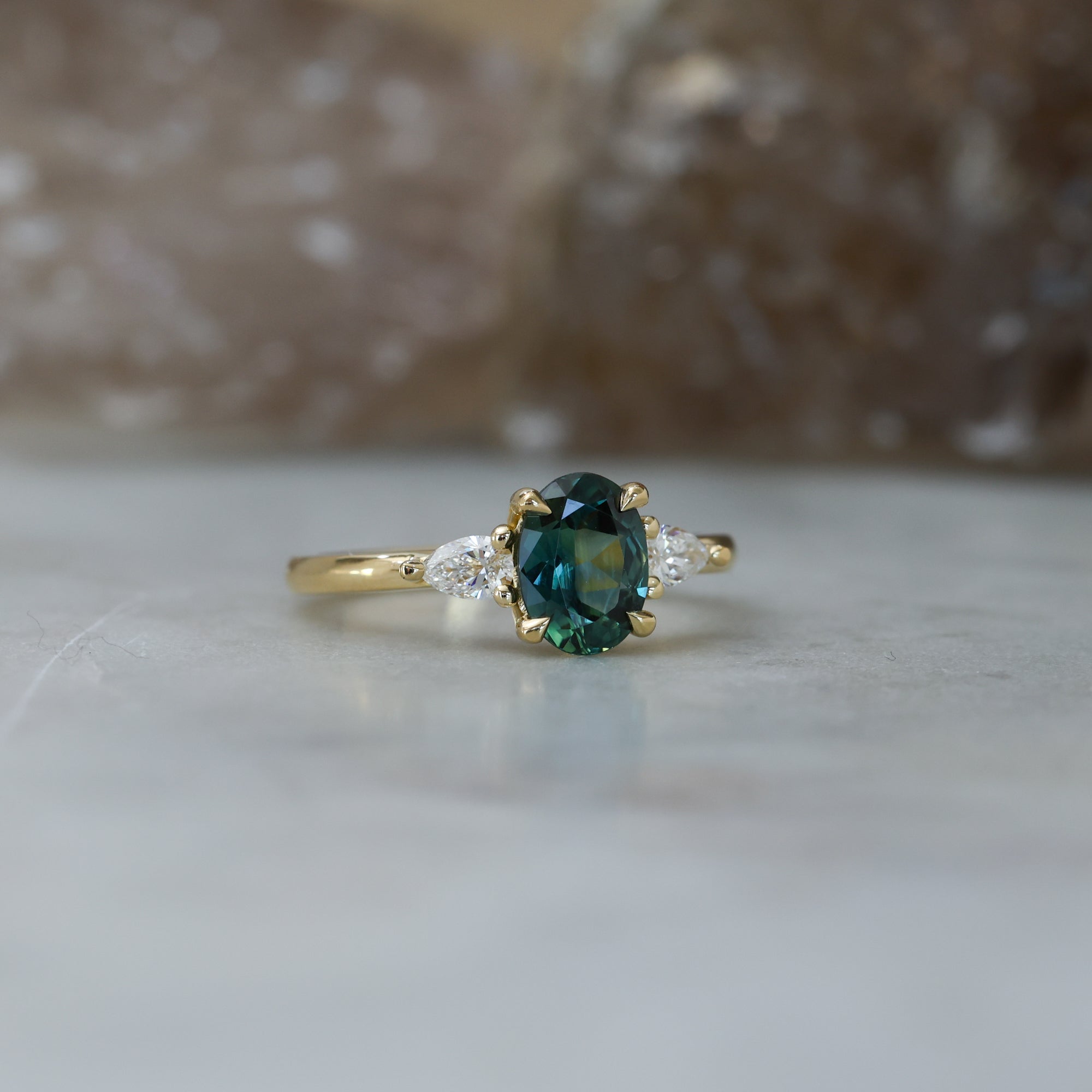 1.31ct Oval Cut australian Parti sapphire trilogy engagement ring side view