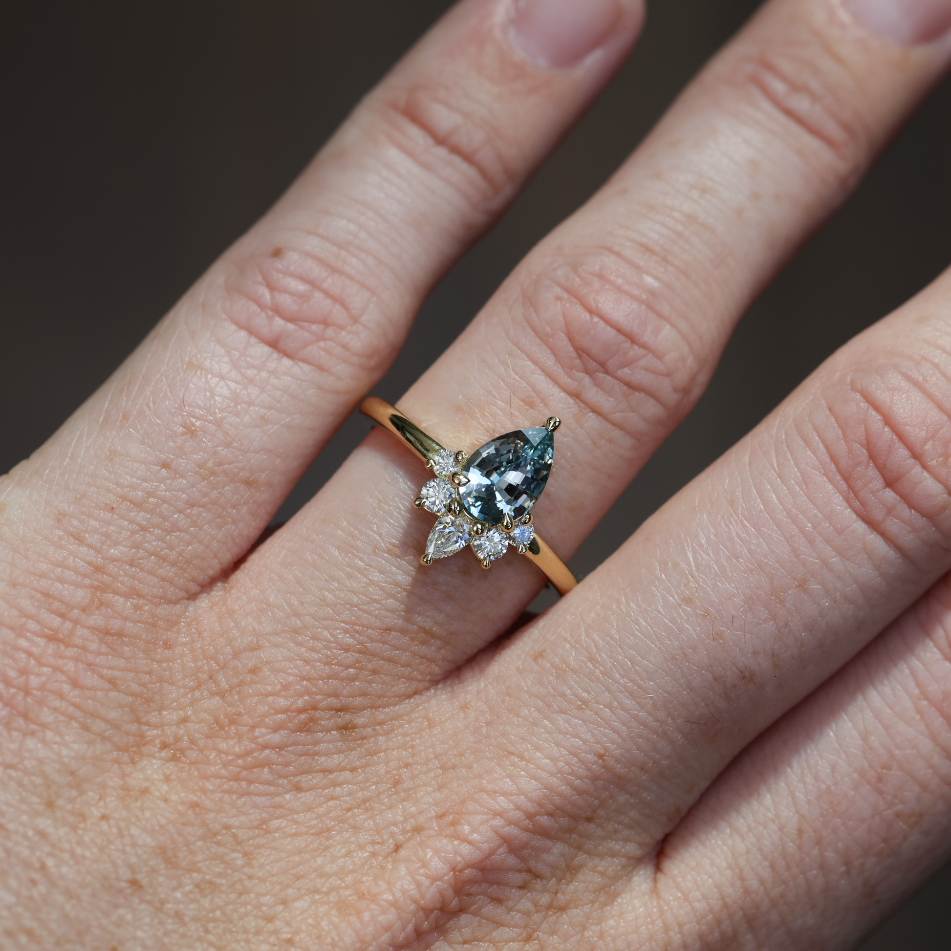 1.32ct madagascan Sapphire & Diamond half halo engagement ring on hand