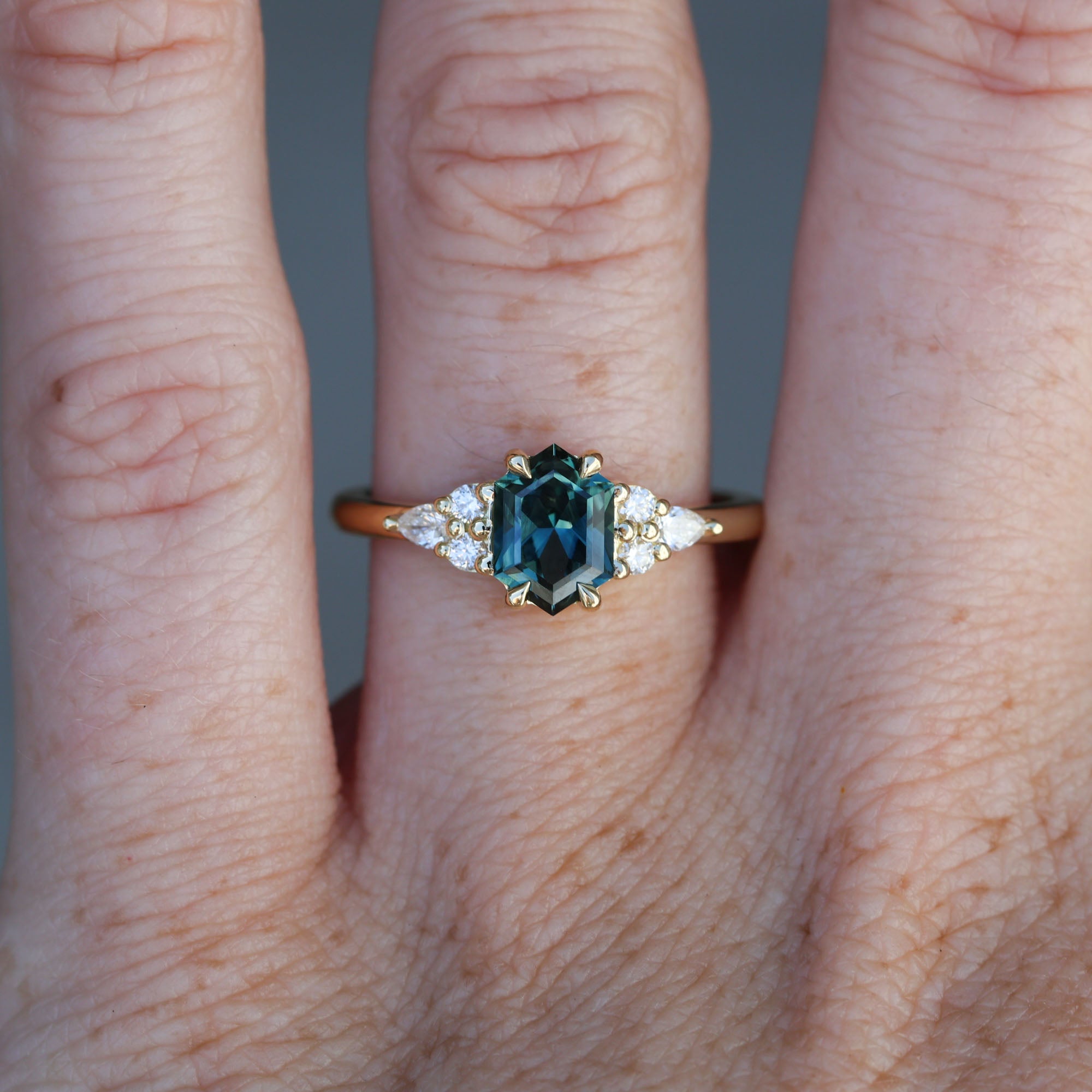 1.35ct Elongated hexagon Australian Parti Sapphire 7 stone engagement ring on hand