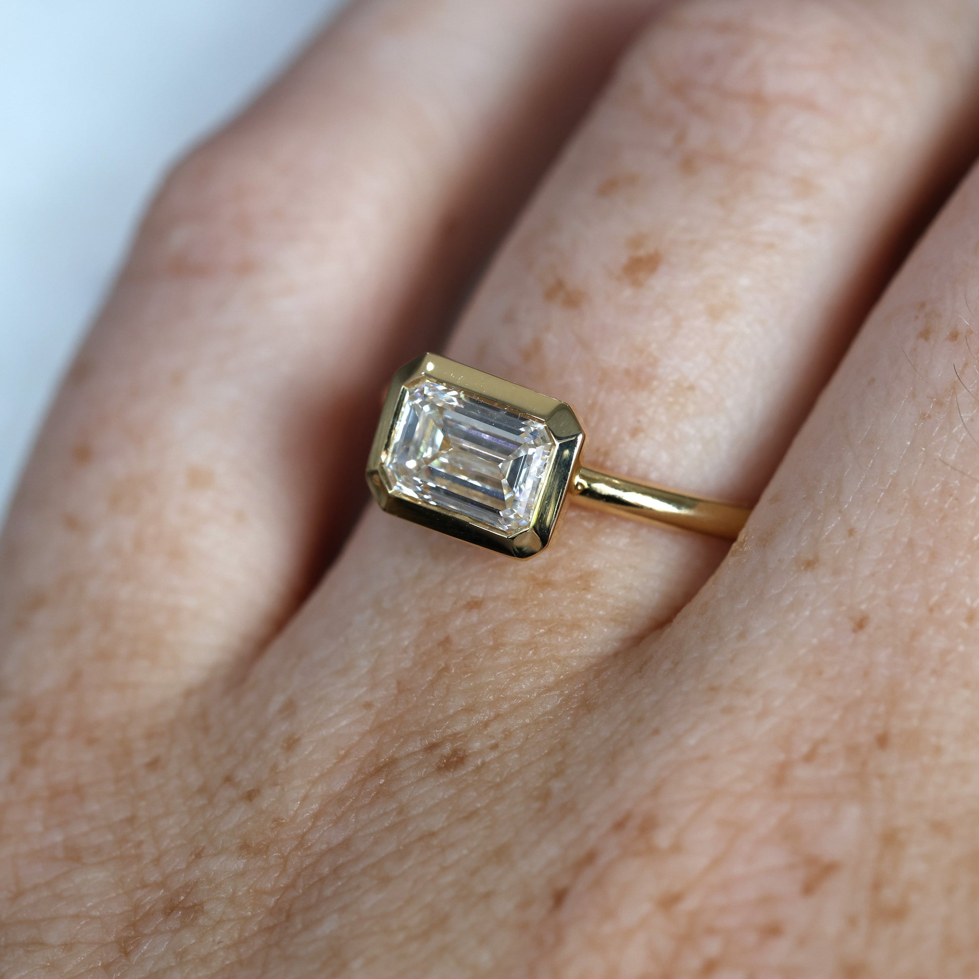 1.36ct Emerald Cut Bezel Engagement ring on hand