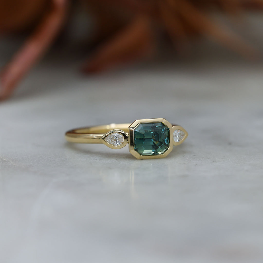 1.51ct Madagascan Sapphire and diamond Bezel trilogy engagement ring side view