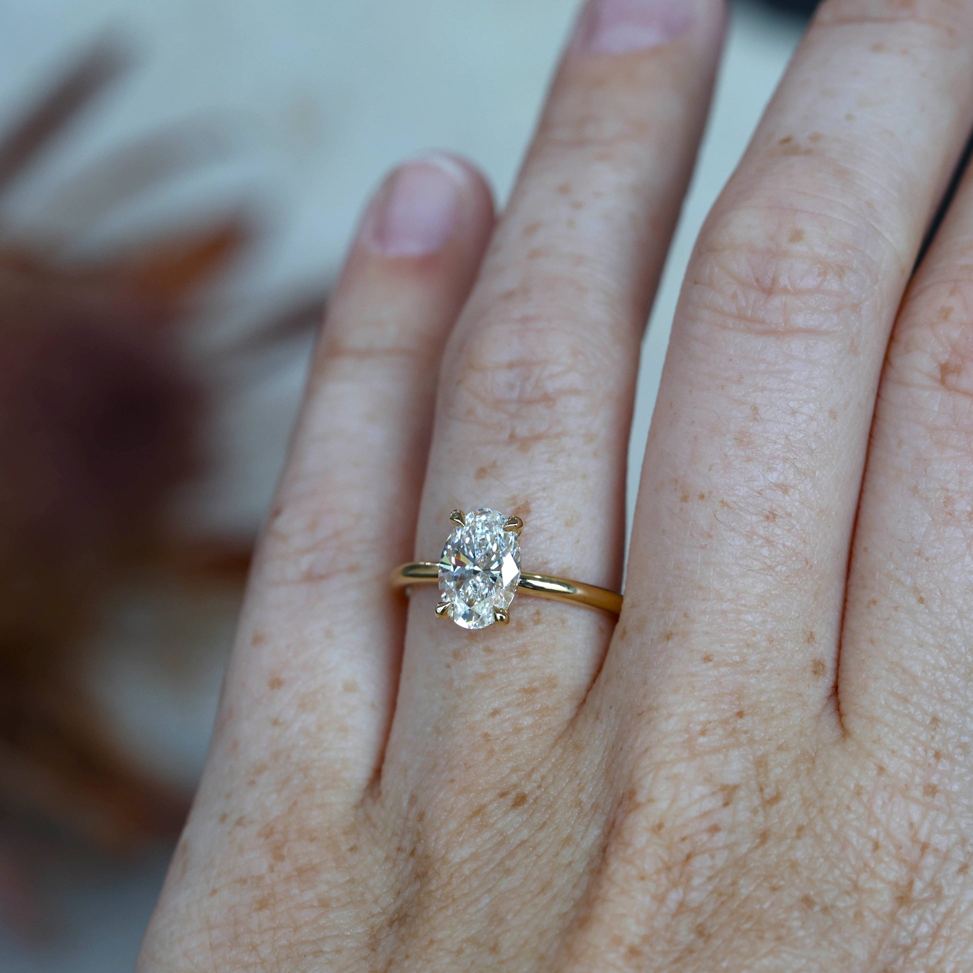 1.59ct Oval cut diamond solitaire engagement ring on hand