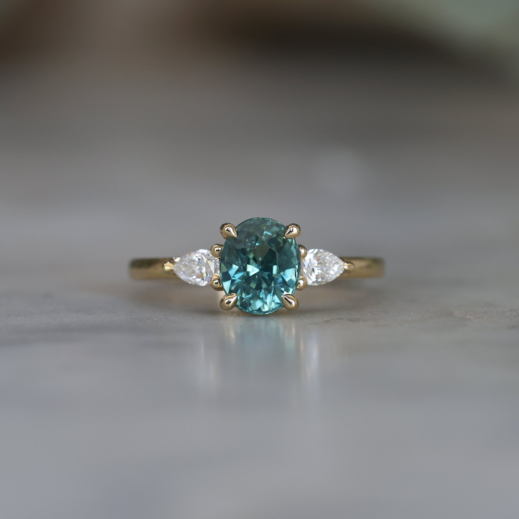 OVAL CUT TEAL SAPPHIRE / TRILOGY RING