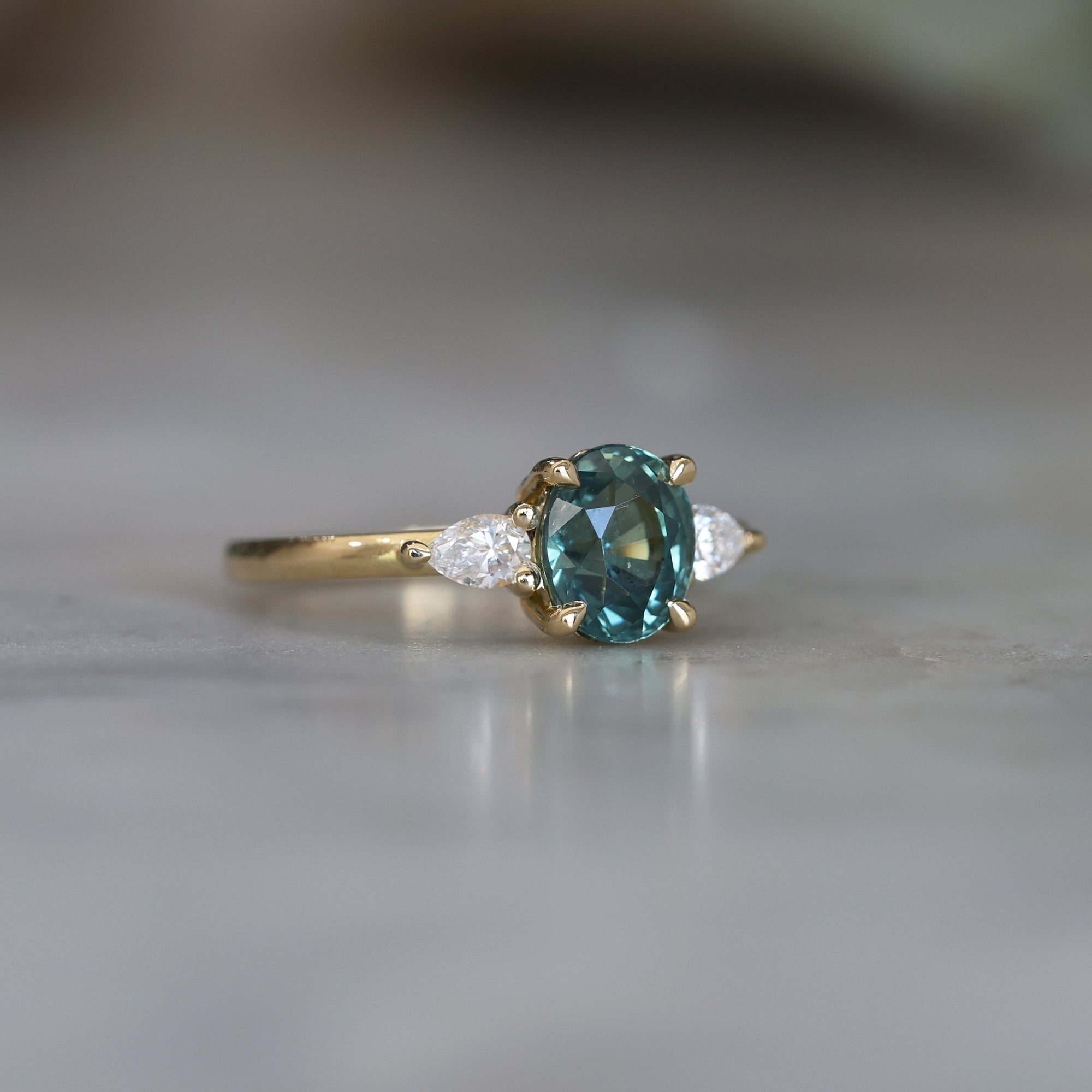 OVAL CUT TEAL SAPPHIRE / TRILOGY RING