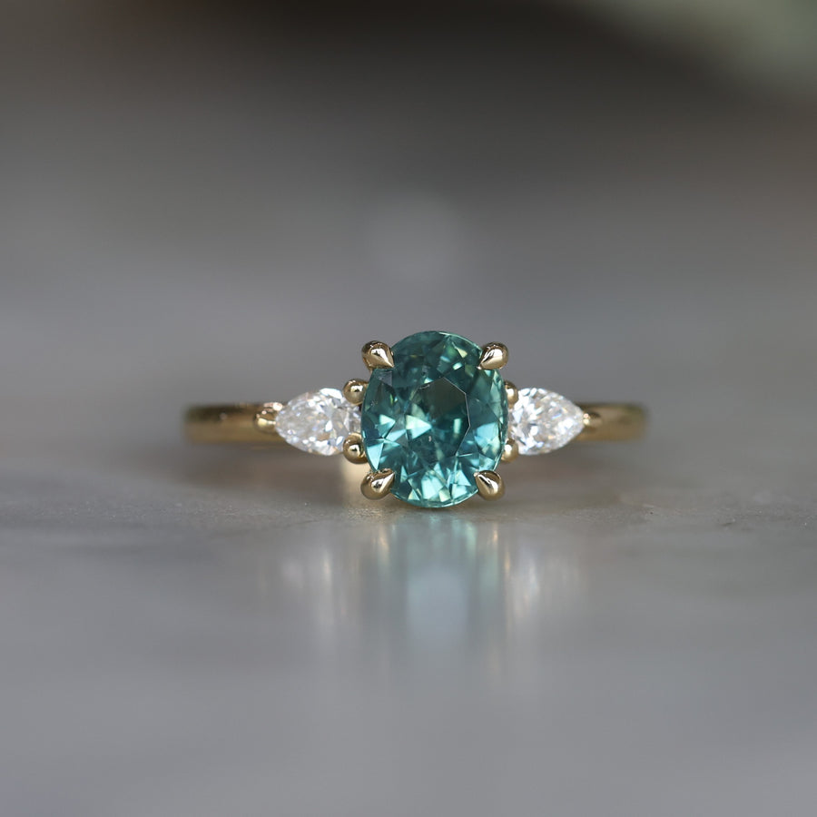 OVAL CUT TEAL SAPPHIRE / TRILOGY RING