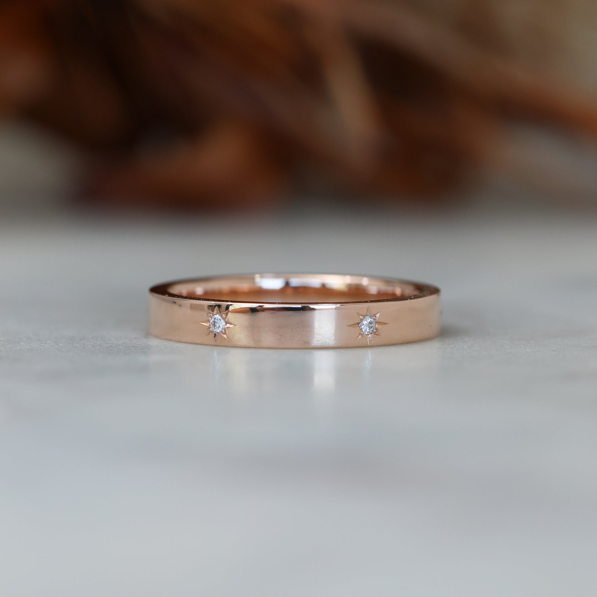 gold cigar wedding band with star set diamonds rose gold
