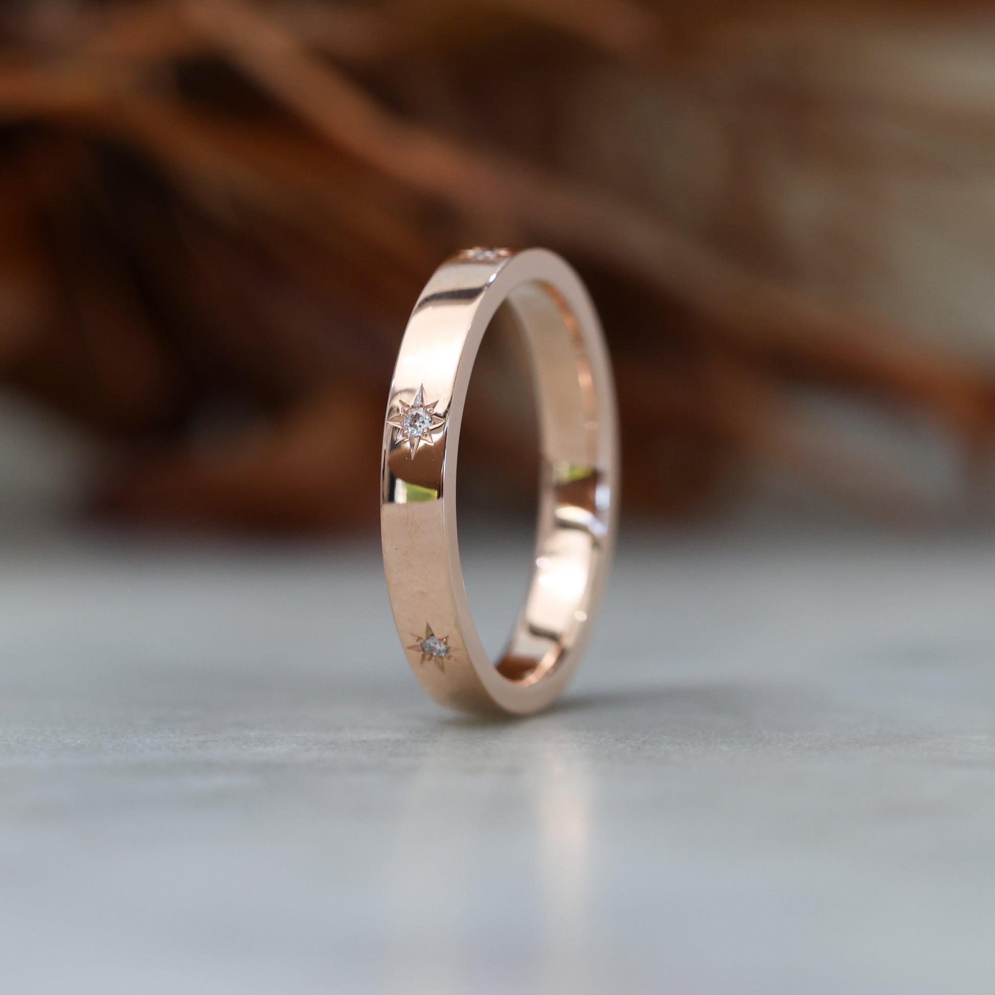 gold cigar wedding band with star set diamonds rose gold