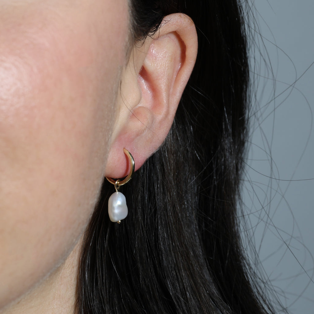 classic pearl hoop earrings in ear
