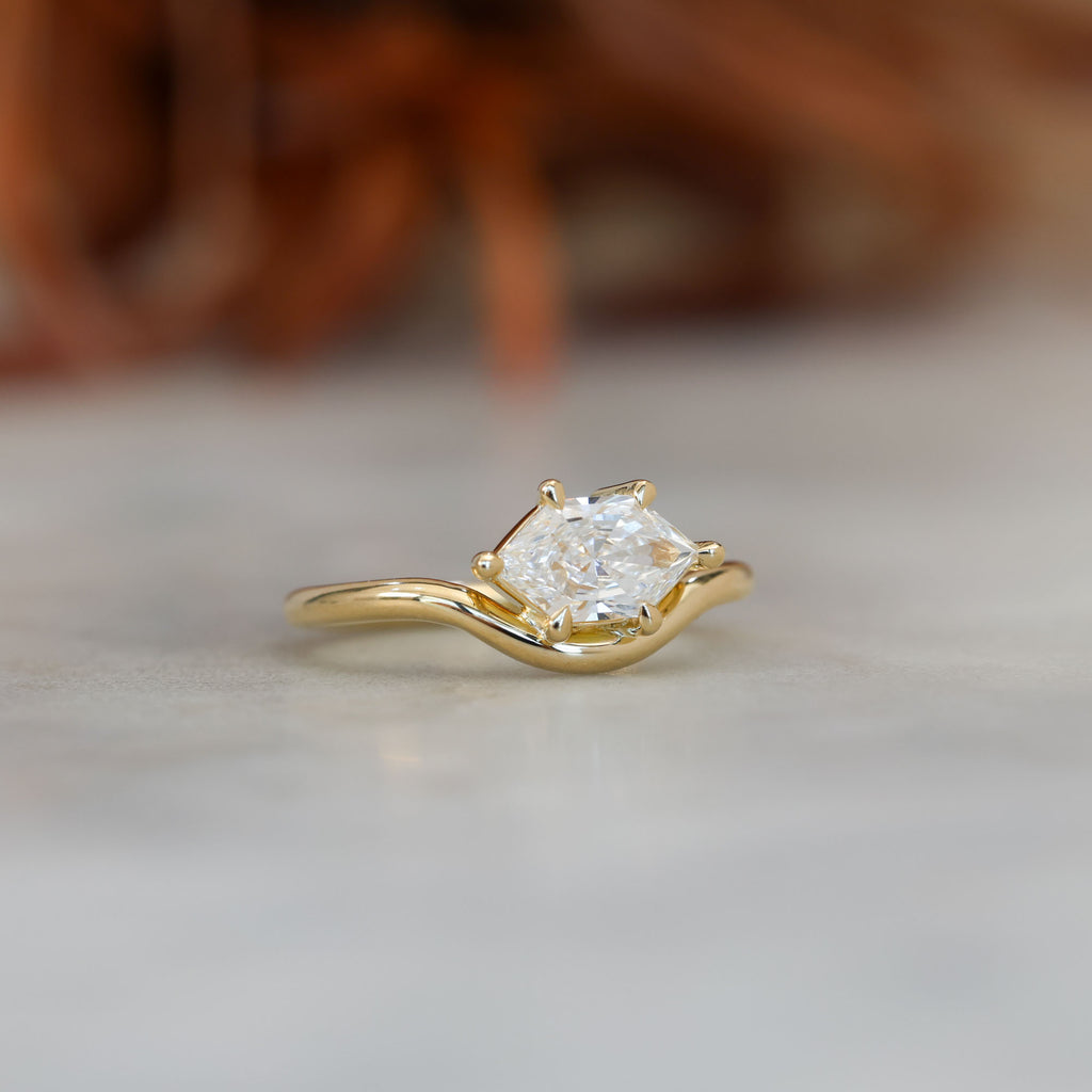 eden 1.00ct elongated hexagon diamond on curved yellow gold band side