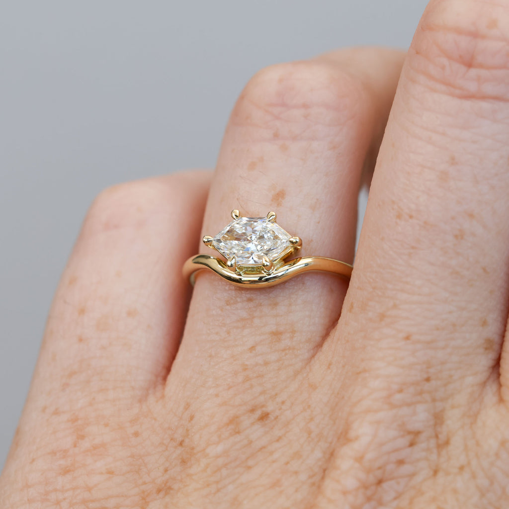 eden 1.00ct elongated hexagon diamond on curved yellow gold band
