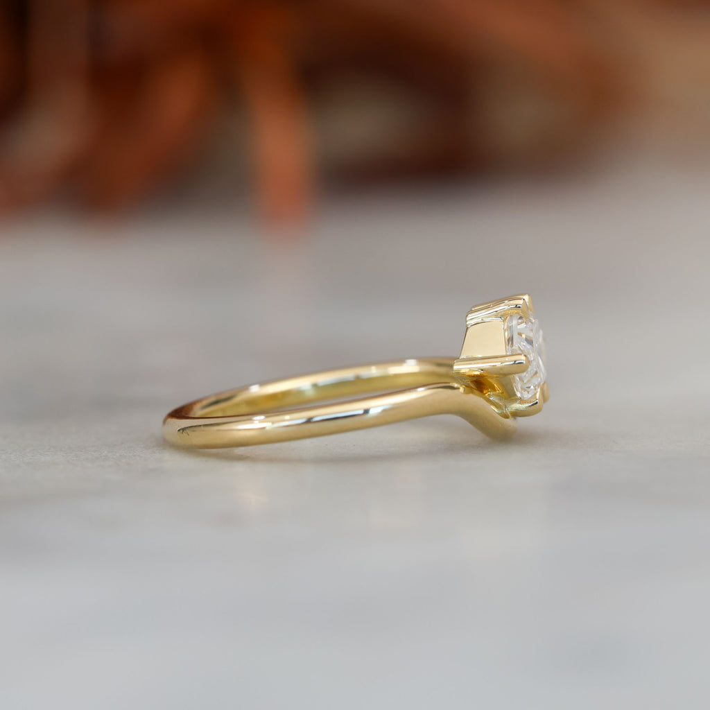 eden 1.00ct elongated hexagon diamond on curved yellow gold band