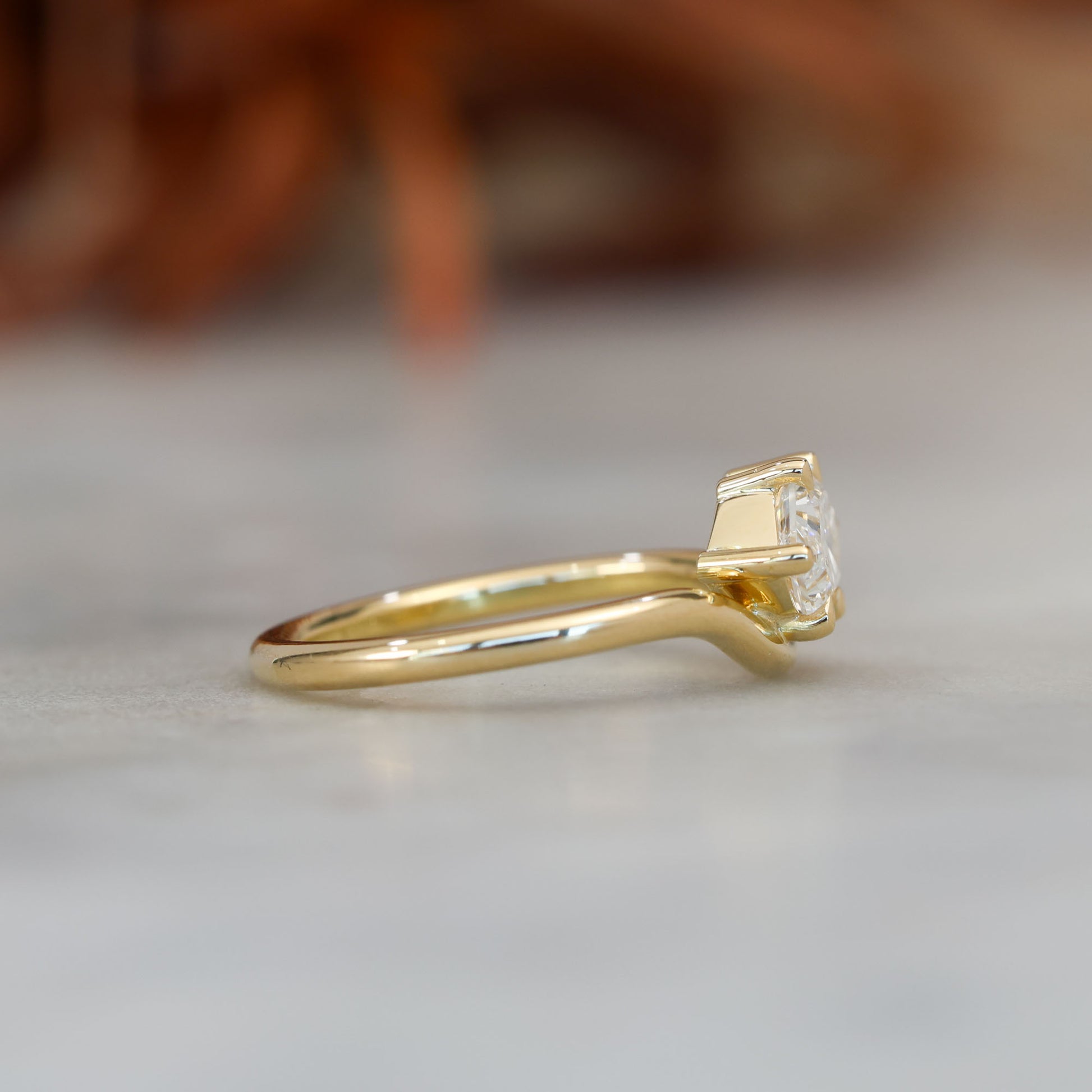 eden 1.00ct elongated hexagon diamond on curved yellow gold band