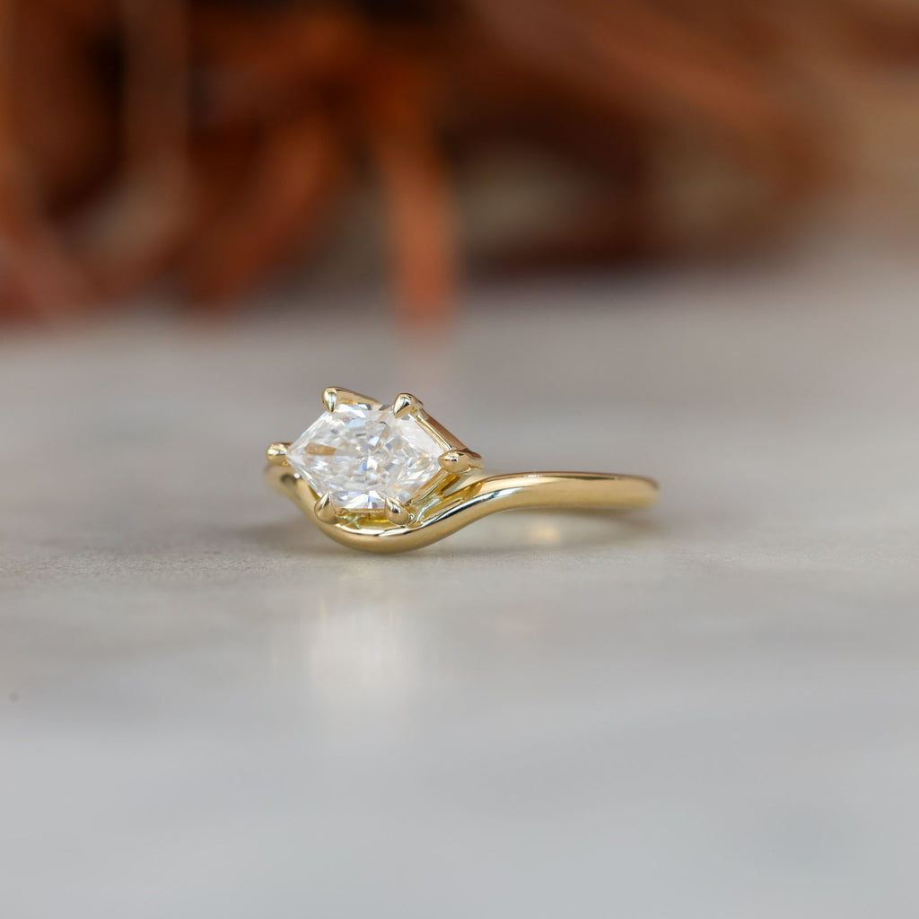 eden 1.00ct elongated hexagon diamond on curved yellow gold band