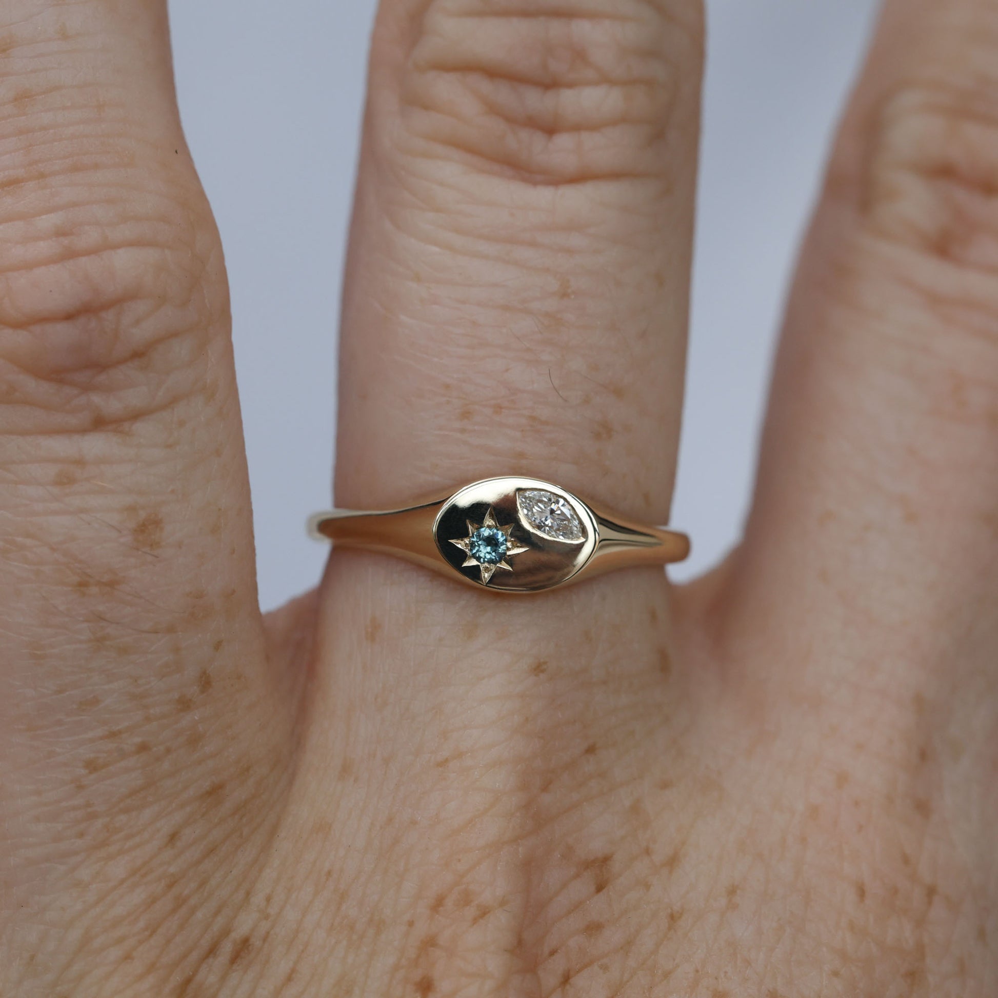 Ellipse star set australian sapphire and diamond signet ring on hand