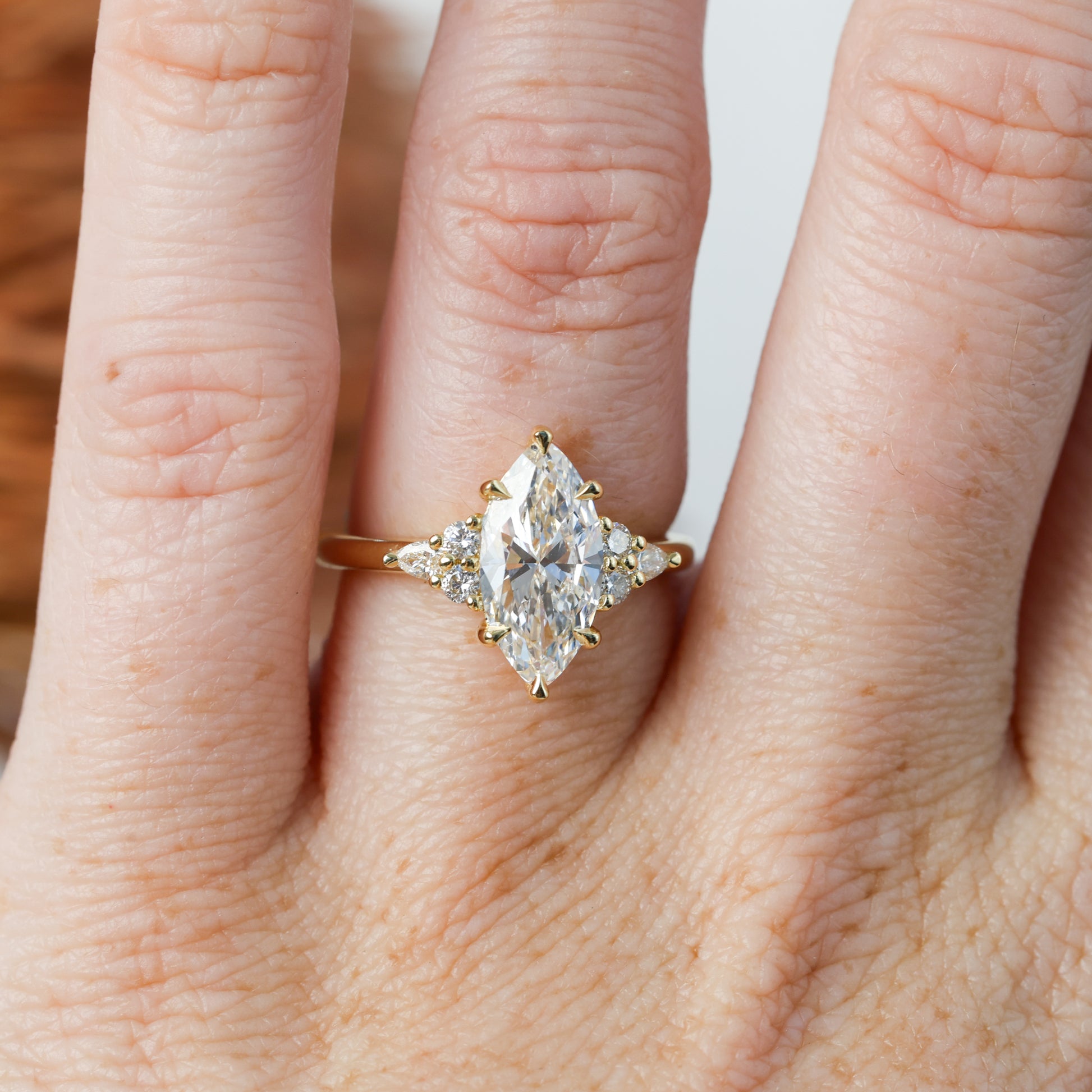 2.01ct marquise cut diamond engagement ring, crafted in yellow gold on hand