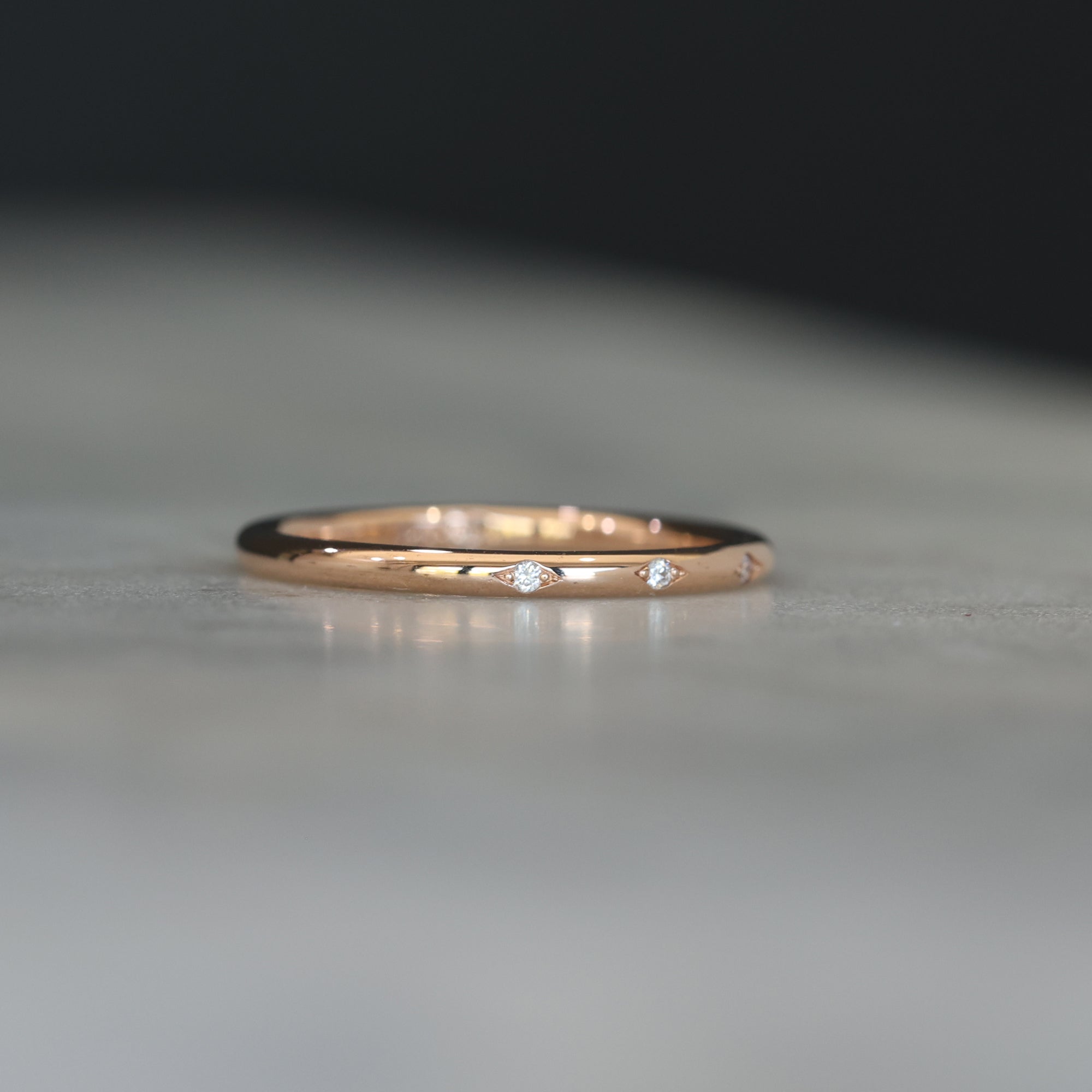 Flat diamond wedding band with star details side profile