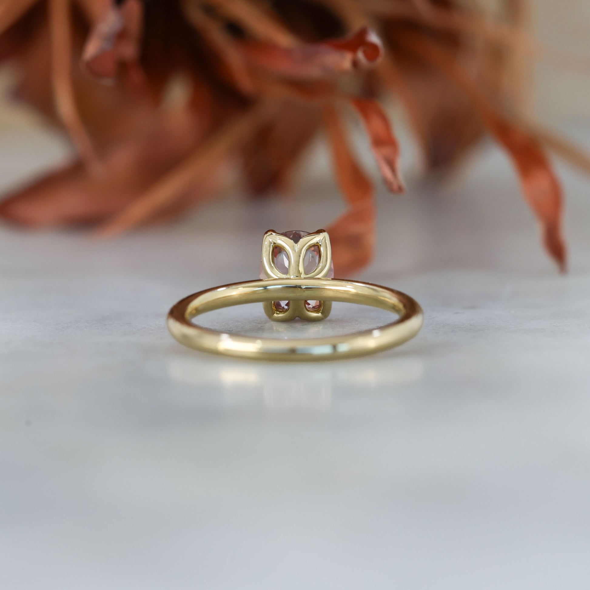 peach 1.15ct oval cut madagascan sapphire engagement ring with a stardust band