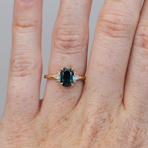 1.58ct oval cut Australian Parti Sapphire and diamond engagement ring yellow gold on hand