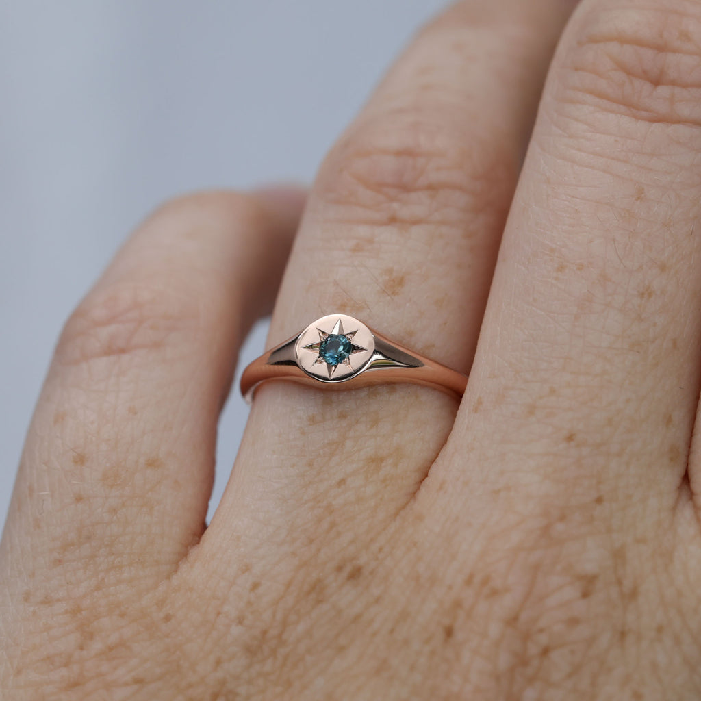 round star set australian sapphire signet ring in rose gold on hand