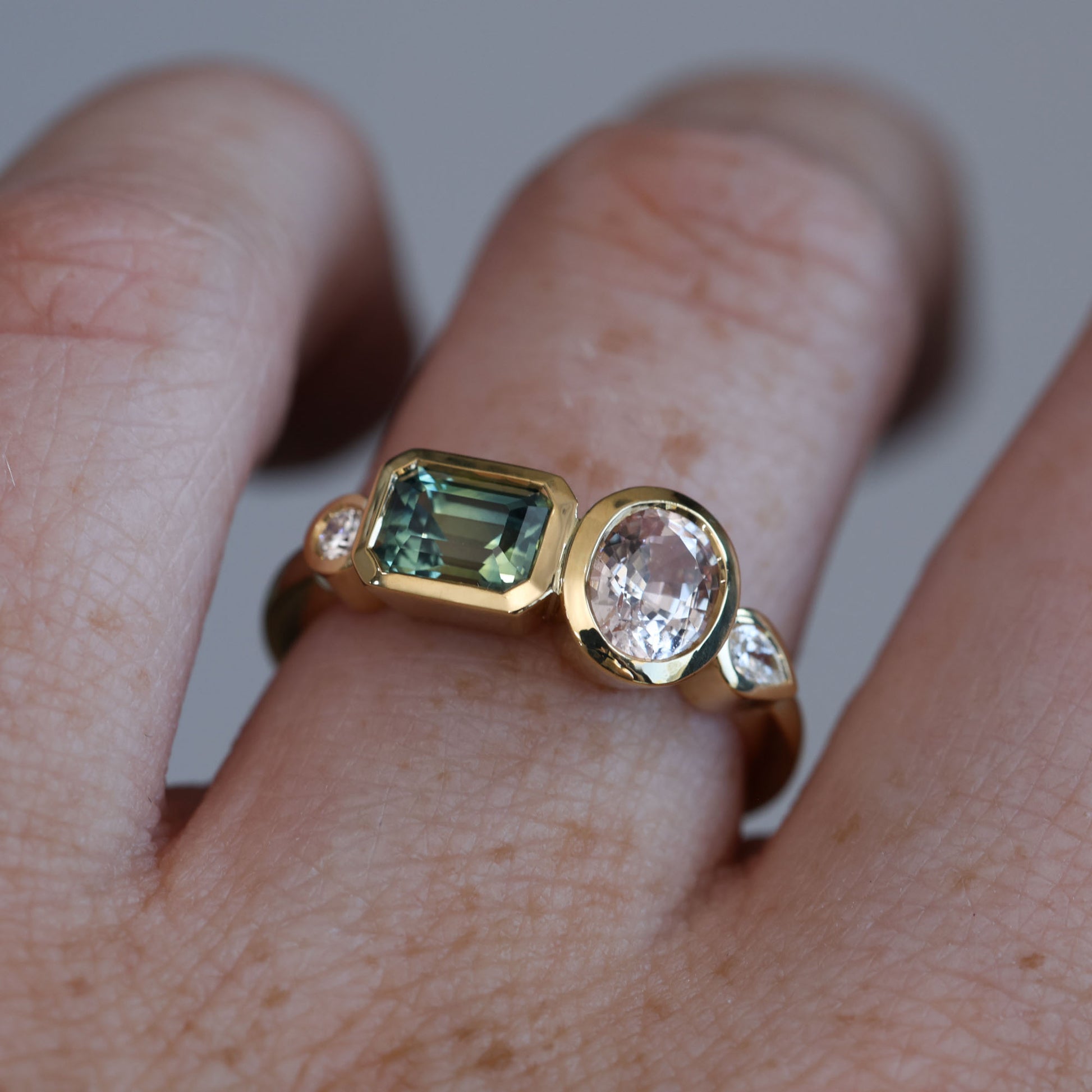 Sapphire and diamond asymmetric cluster ring, crafted in 18ct yellow gold on hand